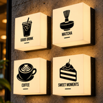 Veggkube med logo: fire veggmonterte kubelamper med kaffe-, matcha- og kakeikoner